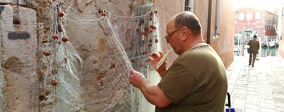Responsible tourism celebrates the local way of life Repairing a fishing net in Venice
