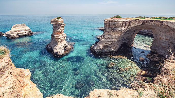 The magical waters and cliffs of the Faraglioni of Sant'Andrea Colosseum